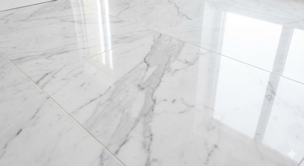 Glossy white marble floor tiles with gray veining and window reflections.